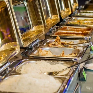 Hot buffet trays filled with rice, chapati, curries, and gravies at Manappatti Chettinad Catering